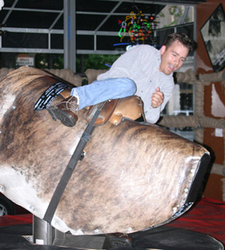 Falling off of the mechanical bull at Cowgirls Inc